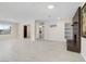Spacious living room featuring sleek tile floors, a brick fireplace, and abundant natural light at 2375 Marion St, Las Vegas, NV 89104