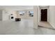 Bright living room with light-colored tile flooring, a decorative fireplace, and large windows at 2375 Marion St, Las Vegas, NV 89104