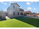This home features a large backyard with a grass lawn, fire pit and patio at 258 Chamomile Dr, Henderson, NV 89015