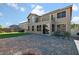 This home features a large backyard with a grass lawn, fire pit and patio at 258 Chamomile Dr, Henderson, NV 89015