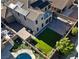 An aerial view showcases an attractive backyard including a pool, artificial turf, patio, and desert landscaping at 258 Chamomile Dr, Henderson, NV 89015