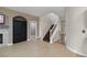Inviting foyer featuring tile flooring, a staircase, and access to multiple rooms at 258 Chamomile Dr, Henderson, NV 89015