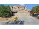 Charming two-story home featuring a three car garage and desert landscaping, with appealing neutral-toned facade at 258 Chamomile Dr, Henderson, NV 89015