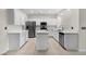 Modern kitchen with white cabinets, quartz countertops, stainless steel appliances, and center island at 258 Chamomile Dr, Henderson, NV 89015