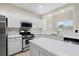 This lovely kitchen boasts white cabinets, a center island, and stainless steel appliances at 258 Chamomile Dr, Henderson, NV 89015
