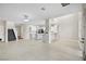 Spacious living area with tile floors, staircase, and open layout to the kitchen at 258 Chamomile Dr, Henderson, NV 89015
