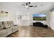 Cozy living room with wood floors, media center, ceiling fan and comfortable seating at 258 Chamomile Dr, Henderson, NV 89015
