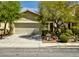 Charming home featuring mature trees, manicured bushes, and a spacious two-car garage at 3048 Scalise Ct, Las Vegas, NV 89141