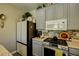 Modern kitchen featuring grey cabinets, stainless steel appliances, and updated countertops at 3048 Scalise Ct, Las Vegas, NV 89141