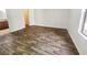 Empty bedroom with wood-look floors, a window, a closet, and an ensuite bathroom at 3135 S Mojave Rd # 152, Las Vegas, NV 89121