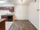 Galley kitchen with wooden cabinets, dark appliances, and an eat-in dining area at 3135 S Mojave Rd # 152, Las Vegas, NV 89121