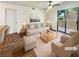 Bright, staged living room featuring a ceiling fan, neutral furniture, and access to a patio at 3135 S Mojave Rd # 152, Las Vegas, NV 89121