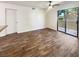 Empty living room with a ceiling fan, wood-look floors, and a sliding glass door to the outside at 3135 S Mojave Rd # 152, Las Vegas, NV 89121
