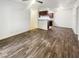 Open living room with wood-look floors and an adjacent kitchen space at 3135 S Mojave Rd # 152, Las Vegas, NV 89121