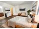 Staged bedroom with neutral decor, wood-look floors, and artwork at 3135 S Mojave Rd # 152, Las Vegas, NV 89121