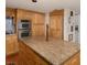 Spacious kitchen includes an island with granite countertops and stainless steel appliances at 3233 Southridge Ave, Las Vegas, NV 89121