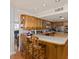 Well-lit kitchen showcases custom cabinets, tile countertop, and a convenient breakfast bar at 3233 Southridge Ave, Las Vegas, NV 89121