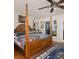 A gorgeous wooden four poster bed is the focal point of this main bedroom with wood floors at 3233 Southridge Ave, Las Vegas, NV 89121