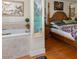 Relax in the luxurious primary bedroom and ensuite bathroom with separate soaking tub at 3233 Southridge Ave, Las Vegas, NV 89121