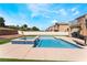 Backyard with pool, green turf, fence and exterior view of home at 3309 Green Ice Ave, North Las Vegas, NV 89081