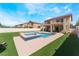 Large backyard featuring a pool, patio, balcony and artificial turf at 3309 Green Ice Ave, North Las Vegas, NV 89081