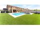 Spacious backyard featuring a refreshing pool, seating and green artificial turf at 3309 Green Ice Ave, North Las Vegas, NV 89081