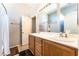 Bathroom featuring double sinks, wood cabinetry, and a shower-tub combo, providing ample space and functionality at 3309 Green Ice Ave, North Las Vegas, NV 89081