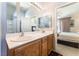 Bathroom with double sink vanity, wood cabinets and a view to the main bedroom, offering an open and functional layout at 3309 Green Ice Ave, North Las Vegas, NV 89081