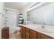 Well-lit bathroom featuring a shower-tub combo, wood cabinets and white countertops, offering a clean and functional space at 3309 Green Ice Ave, North Las Vegas, NV 89081
