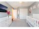 Cozy Bedroom featuring a white crib, gray walls, and a TV, creating a functional and comfortable space at 3309 Green Ice Ave, North Las Vegas, NV 89081