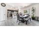 Dining room with a large table, adjacent to a modern kitchen and stainless appliances at 3309 Green Ice Ave, North Las Vegas, NV 89081