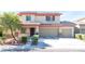 Inviting home with a well-maintained lawn, porch, and three-car garage at 3309 Green Ice Ave, North Las Vegas, NV 89081
