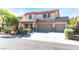 Charming two-story home featuring a three-car garage and inviting front porch at 3309 Green Ice Ave, North Las Vegas, NV 89081