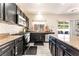 Modern kitchen featuring granite countertops, dark wood cabinets, and stainless steel appliances at 3309 Green Ice Ave, North Las Vegas, NV 89081