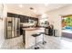 Spacious kitchen with a center island, stainless steel appliances, and access to the backyard pool at 3309 Green Ice Ave, North Las Vegas, NV 89081