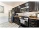 Kitchen with granite counters, stainless steel appliances, and dark cabinetry at 3309 Green Ice Ave, North Las Vegas, NV 89081