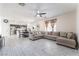 Open-concept living room with tile floors, large sectional sofa, and modern ceiling fan at 3309 Green Ice Ave, North Las Vegas, NV 89081