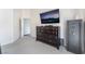 Primary bedroom featuring carpet, dark wood dresser, wall-mounted TV, and neutral decor, offering a cozy retreat at 3309 Green Ice Ave, North Las Vegas, NV 89081