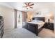 Comfortable primary bedroom with a dark wood furniture set, carpet, ceiling fan and access to a balcony at 3309 Green Ice Ave, North Las Vegas, NV 89081