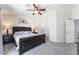 Comfortable main bedroom with a dark wood furniture set, carpet, and ceiling fan with light at 3309 Green Ice Ave, North Las Vegas, NV 89081