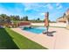 Backyard featuring a refreshing swimming pool and well-maintained artificial grass at 3309 Green Ice Ave, North Las Vegas, NV 89081