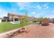 Backyard pool with artificial turf, picnic area and a small storage shed at 3309 Green Ice Ave, North Las Vegas, NV 89081