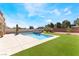Backyard pool and jacuzzi surrounded by concrete patio and green turf, perfect for outdoor relaxation and entertainment at 3309 Green Ice Ave, North Las Vegas, NV 89081