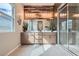 Elegant bathroom with double sink vanity, wood accent wall, and glass-enclosed shower at 3395 Sleeping Hills Ave, Henderson, NV 89044