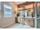 Bright bathroom featuring a double vanity, wood accent wall, and ample natural light at 3395 Sleeping Hills Ave, Henderson, NV 89044