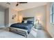 Cozy bedroom with ceiling fan, bedside tables, and stylish gray furnishings at 3395 Sleeping Hills Ave, Henderson, NV 89044