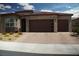 Charming single-story home featuring a brick-accented facade and a spacious two-car garage at 3395 Sleeping Hills Ave, Henderson, NV 89044