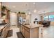 Well-equipped kitchen with stainless appliances, granite counters and island with barstool seating at 3395 Sleeping Hills Ave, Henderson, NV 89044