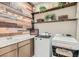 Well-organized laundry room with modern appliances, stylish wood accents, and ample storage space at 3395 Sleeping Hills Ave, Henderson, NV 89044