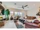 Open-concept living room features a large fan, recessed lights, tile floor, and access to the backyard at 3395 Sleeping Hills Ave, Henderson, NV 89044